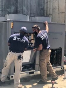 plumbing technicians working on a commercial service